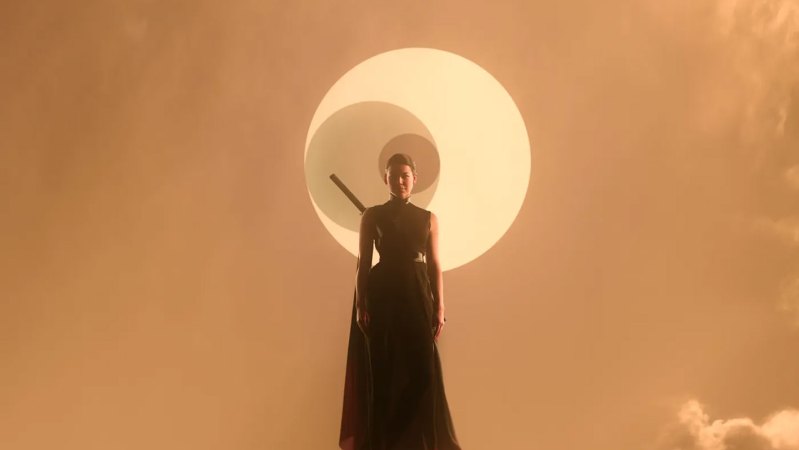 A woman is pictured in front of three overlapping circles, representing the three stars of an alien star system, in an image from the Netflix show "3 Body Problem."